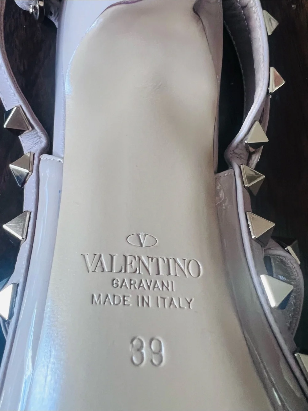 Valentino Garavani patent nappa leather pump feature iconic platinum-finish stud